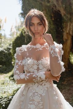 a woman in a wedding dress posing for the camera