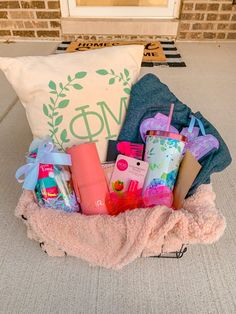 a basket filled with personal care items on top of a floor next to a pillow