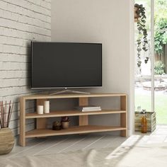 a television stand with a flat screen tv on it in front of a brick wall