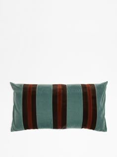 a green and brown striped pillow on a white background