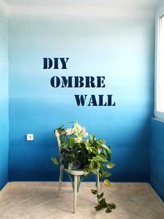 a chair sitting in front of a blue wall with the words diy ombre wall painted on it