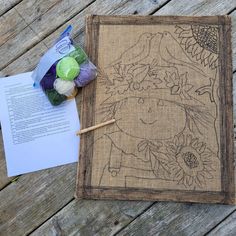 a piece of fabric and yarn sitting on top of a wooden table