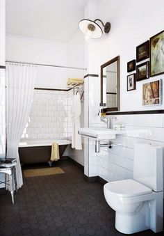 a bathroom with a toilet, sink, and bathtub in it's center