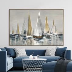 a living room with blue couches and sailboats on the water in an abstract painting