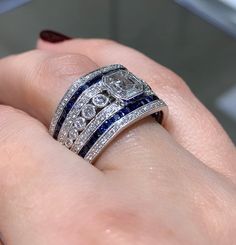 Dazzle everyone around you whenever you are wearing this mesmerizing sapphire and diamond ring. It looks so royal, and that is exactly what you will feel whenever you slip it on.Metal: 18K White GoldRound 136 Diamond Weight: 0.63ct t.w.Diamond 91 Baguette weight: 0.46ctw Sapphires 46 : 1.27ct t.w. Estimated production time is 4 - 5 weeks. Luxury Lab-created Sapphire Ring With Diamond Cut, Luxury Sapphire-colored Diamond Ring With Diamond Cut, Luxury Sapphire-colored Diamond Ring, Luxury Sapphire Diamond Ring With Diamond Cut, Luxury Diamond Ring With Lab-created Sapphire And Diamond Cut, Luxury Sapphire Diamond Ring With Vvs Clarity, Dazzling Sapphire Ring With Diamond, Luxury Asscher-cut Sapphire Ring With Diamond Details, Asscher Cut Sapphire Ring With Diamond Detail