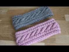 two knitted headbands sitting on top of a wooden floor