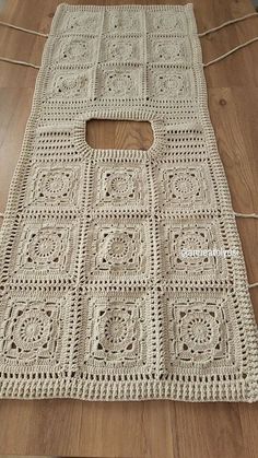 a crocheted bag sitting on top of a wooden floor