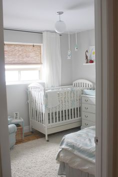 a baby's room with a crib, dresser and bed in it is shown