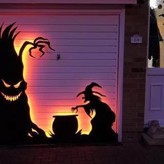 a garage door decorated to look like it has been carved into the shape of two witches