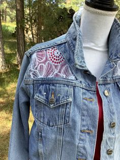 Embellished denim jacket, size large. Measures 20 1/2" across chest when buttoned. Light wash denim, rivet details, button closure. I cut out the back and front yoke and insert a beautiful light blue, sheer floral embroidered fabric. It was difficult to photograph the embroidered fabric, but is a beautiful blue that matches the jacket perfectly. Spot clean only!  This gorgeous jacket is one-of-a-kind, and would make an awesome gift for the women who appreciates unique items! Spring Recycled Denim Jacket With Button Closure, Spring Recycled Denim Button-up Jacket, Fitted Denim Jacket In Recycled Denim, Fitted Recycled Denim Jacket, Fitted Long Sleeve Denim Jacket In Recycled Denim, Fitted Medium Wash Recycled Denim Jacket, Fitted Light Wash Denim Jacket With Snap Buttons, Fitted Medium Wash Denim Jacket For Festival, Fitted Denim Outerwear For Festival