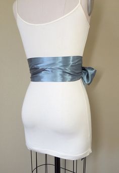 "Steel Gray Sash Silver Gray Satin Sash Obi Wrap Belt Long Silver Sash Wedding Accessories Wedding Gown Bridal Sash Satin Swank Make this Satin Swank® reversible waist sash the perfect finishing touch for your wedding, bridesmaid, or special occasion dress, or just the right piece to add instant polish to your dress or top. This extra long version is 3.5 inches wide, 120 inches long, and will wrap around most waist sizes two times with a generous length remaining to tie in a bow or a simple knot Elegant Blue Sashes For Wedding, Wedding Sashes With Satin Finish, Wedding Satin Tie Back Sash, Fitted Bridal Belt With Ribbon For Wedding, Fitted Ribbon Sash For Wedding, Gray Sash, Obi Wrap Belt, Gown Bridal, Wedding Sash Belt