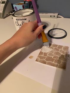 a person is using a paint roller to decorate a wall