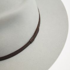 The Dylan is made with our hardest felt to date, giving it a stiff fit that is sure to break in like a beauty. It sports a wide raw edge stiff brim, tear drop crown, and features a handmade leather trim that is manufactured in a solar and wind powered facility that collects 27,300 tons of rainwater per year, and uses 50% natural light energy. Fit: Due to the stiff/firm nature of our hard wool, depending on your head shape, the Dylan generally runs small for most. While diameter is important, hea Everyday Leather Fedora With Flat Brim, Classic Adjustable Felt Hat For Town, Adjustable Classic Felt Hat For Town, Classic Gray Hat Bands With Flat Brim, Classic Gray Flat Brim Hat Band, Classic Flat Brim Felt Hat For Town, Fur Felt Hat With Flat Crown, Solid Fur Felt Hat With Flat Crown, Classic Fur Felt Hat Band With Flat Crown