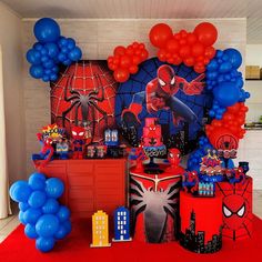 a spiderman birthday party with balloons and decorations