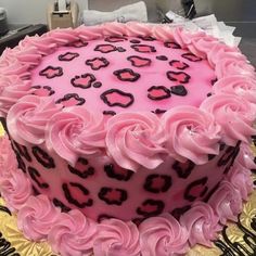 a pink and black leopard print cake on a table