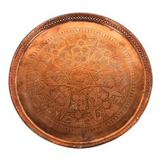 an antique copper plate with intricate designs on it