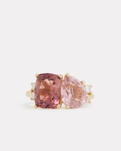 two pink sapphire and diamond ring set in yellow gold with diamonds on each side,