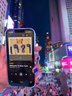 a person holding up a cell phone in the city