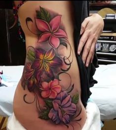 a woman's stomach with flowers on it