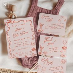 the wedding stationery is laid out on the bed