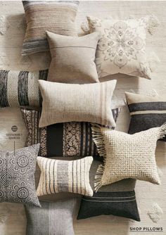 many pillows are arranged on top of each other in different colors and patterns, with the words shop pillows written below them