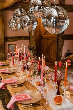 a long table is set with pink napkins and place settings