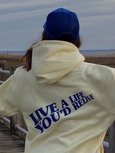 a person standing on a boardwalk looking at the ocean