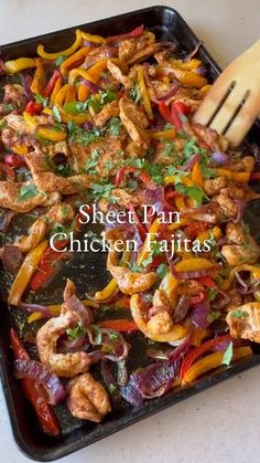 chicken fajitas are being cooked on a sheet pan