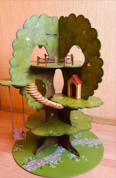 a tree house made out of cardboard with trees and houses on the top of it