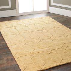 a yellow rug on the floor in a room