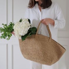 Our Sag Harbor Sisal Tote is handmade by artisans in Kenya from durable elephant grass. The versatile sisal tote is perfect for a trip to the farmers market, a day at the beach or as an everyday carryall. Tote measures 23" w x 17" t (including handles) x 11" dHand woven in Kenya. Eco-friendly Crochet Palm Leaf Bag For Travel, Eco-friendly Palm Leaf Crochet Bag For Travel, Natural Jute Straw Bag For Travel, Fair Trade Jute Straw Bag For Beach, Natural Handwoven Burlap Straw Bag, Natural Crochet Bag For Travel, Natural Burlap Handwoven Straw Bag, Natural Color Fair Trade Straw Bag For Beach, Fair Trade Natural Crochet Bag For Travel