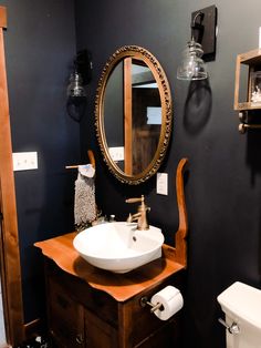 a bathroom with a sink, mirror and toilet