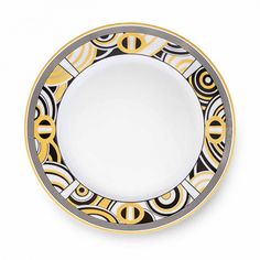 a black, yellow and white plate with an abstract design on the rim is shown