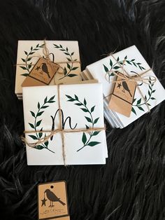 four cards tied up with twine and string on top of black furnishing