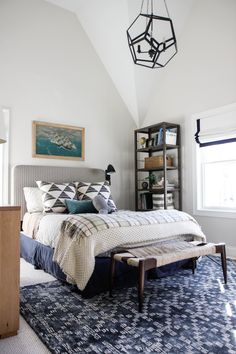 a bedroom with white walls and blue carpet