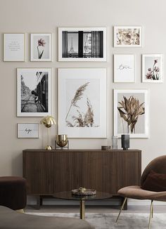 a living room filled with furniture and pictures on the wall