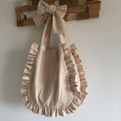 a bag hanging on the wall with a bow