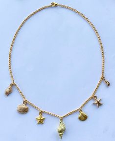 Introducing the cutest Dainty Gold Conch Shell Charm Necklace, adorned with an array of exquisite beach-inspired charms. This stunning piece uses a simple gold chain to captures the essence of the ocean, bringing a touch of elegance and sophistication to any ensemble.  The centerpiece of this necklace is a radiant gold conch shell, symbolizing tranquility, beauty, and the serenity of the coast. Adorning either side of the conch are intricately designed gold starfish, gold clam shells, and gold s Cheap Starfish Charm Jewelry For Vacation, Necklaces With Charms, Dainty Beach Jewelry With Delicate Chain, Beach Jewelry With Dangling Charms, Beach Jewelry With Charms In Ocean-inspired Style, Dainty Beach Necklace With Delicate Chain, Dainty Necklace With Delicate Chain For Beach, Handmade Gold Charm Necklace For Vacation, Dainty Clavicle Chain Necklace For Beach