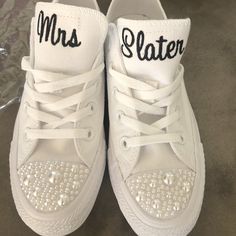 a pair of white tennis shoes with the words mr and mrs written on each shoe