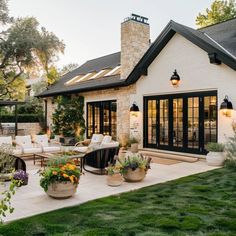 an outdoor patio with seating and potted plants