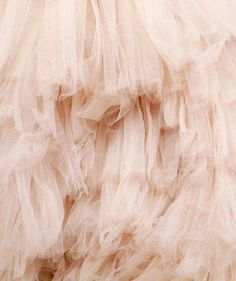 the back of a dress with ruffles is shown in this close up photo