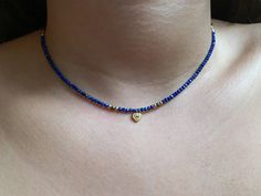 Tiny Lapis lazuli necklace, dainty gold gemstone necklace, silver choker for women, minimalist necklace, healing crystal necklace Dainty choker with tiny Lapis Lazuli beads and a small sterling silver heart charm with cz. These simple, delicate and versatil choker that you can wear at any occassion. Confortable to use and wear, is the perfect outfit for your day. You can combinate with other dainty chokers or necklaces at the same time. Layering necklace. (The gold chain of the picture is not in Gold Gemstone Necklace, Tiny Heart Necklace, Sterling Silver Choker, Dainty Choker, Lapis Lazuli Necklace, Pearls Necklace, Silver Choker, Crystal Choker, Hippie Jewelry