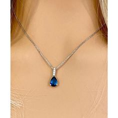 Fourteen karats white gold sapphire and diamond necklace pendant Trending style of layers on layers of gold chains to chunky, retro pendants paired with dainty chokers, layering your necklaces has become an art Necklace measuring 16 inches long Diamond bail hanging pendant 0.35" long with pear shaped sapphire drop Pear Shaped blue sapphire weighing 1.15 carats Sapphire is of royal blue hue Diamond bail weighing 0.10 carats Oval cable chain necklace with spring lock New Necklace Handmade in the USA Some gemstones are very hard to match. The gems that exude subtle color variations are very tough candidates due to color zoning, clarity, and measurements. Our collections challenge our teams in both creativity and know-how.  From the initial drawings through to stone setting and the final polis Teardrop Sapphire Jewelry With Diamond Cut, Formal Teardrop Pendant Jewelry With Detachable Feature, Formal Jewelry With Detachable Teardrop Pendant, Formal Blue Necklace With Detachable Pendant, Teardrop Sapphire Necklace In Fine Jewelry Style, Sapphire Pendant Necklace In Fine Jewelry Style, Blue Jewelry With Detachable Round Pendant, Diamond Teardrop Pendant Clavicle Chain, Sapphire Pendant Diamond Necklace In Fine Jewelry Style