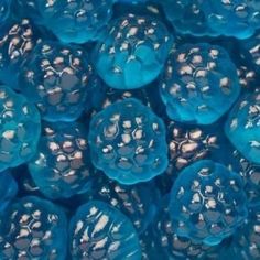 closeup of blue gummy candies with metallic foil on them