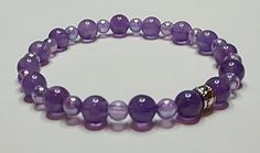 Bracelet made of Amethyst beads and Lavender "Pearl" fishing beads. The Spacer is Silver-plated. This Elastic Bracelet fits up to 7.5-inch wrist. Purple Beaded Stretch Bracelet For Healing, Elegant Hypoallergenic Purple Beaded Bracelets, Purple Pearl Bracelet With Round Beads As Gift, Purple Beaded Pearl Bracelet With Round Beads, Purple Beaded Pearl Bracelet As Gift, Handmade Purple Pearl Bracelet With Round Beads, Adjustable Lavender Beaded Stretch Bracelet, Spiritual Purple Crystal Bracelet With Spacer Beads, Gift Purple Pearl Bracelet With Round Beads