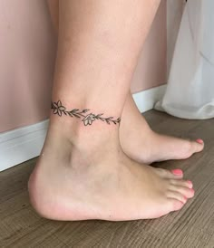 a woman's foot with a small tattoo on the side of her leg,