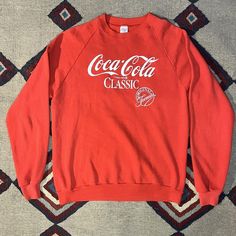 Vintage 1980s Coca-Cola Raglan Sweatshirt. No holes. A few small light stains. Tagged size XL. Measurements Pit to Pit: 22" Length: 28" Underarm Seam to Sleeve End: 22.5" Center of Collar to Sleeve End: 37" We ship Monday through Friday. If there is a problem with the item, just contact us and we will resolve it. We examine the items carefully but sometimes make mistakes. We have been selling vintage clothing on different online platforms since 2003. Vintage Red Long Sleeve Sweatshirt, Red Vintage Long Sleeve Sweatshirt, Retro Red Cotton Sweatshirt, Red Retro Cotton Sweatshirt, Vintage Red Cotton Sweatshirt, Retro Red Sweatshirt With Graphic Print, Retro Red Graphic Print Sweatshirt, Vintage Red Sweatshirt For Streetwear, Vintage Red Top With Letter Print