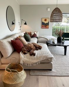 a living room filled with lots of furniture and pillows