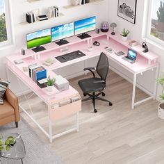 a computer desk with two computers on it