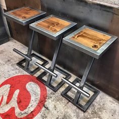 three metal and wood tables sitting next to each other